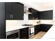 Modern kitchen with black cabinets and stainless steel appliances at 2478 S Lafayette St, Denver, CO 80210