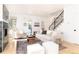 Open living room featuring a fireplace, light walls, and stairs leading upstairs at 2478 S Lafayette St, Denver, CO 80210