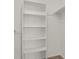 Spacious closet featuring white walls, carpet flooring, and an included shelving unit for organization at 17034 E Tennessee Dr # 106, Aurora, CO 80017