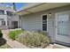 Close up of townhouse exterior with well kept garden and entry door at 17034 E Tennessee Dr # 106, Aurora, CO 80017