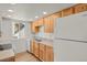 Functional kitchen featuring wooden cabinets, light countertops, and modern appliances at 17034 E Tennessee Dr # 106, Aurora, CO 80017