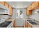 Efficient kitchen featuring wooden cabinets and essential appliances at 17034 E Tennessee Dr # 106, Aurora, CO 80017