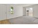 Bright living room featuring plush carpet, natural light, and a patio door at 17034 E Tennessee Dr # 106, Aurora, CO 80017
