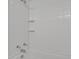 Bright white tiled bathtub and shower combo with updated fixtures at 17034 E Tennessee Dr # 106, Aurora, CO 80017