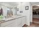 Bathroom featuring double sinks, granite countertops, a large mirror, and access to a walk-in closet at 2682 E 161St Pl, Thornton, CO 80602
