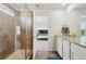 Modern bathroom boasts a glass-enclosed shower, granite vanity, and a view into the main bedroom at 2682 E 161St Pl, Thornton, CO 80602