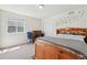 Bright bedroom features a cozy bed, desk area, carpeted floor, and a window with natural light at 2682 E 161St Pl, Thornton, CO 80602