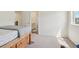 Bright bedroom featuring neutral carpet, closet and a bed frame with drawers, offering ample storage space at 2682 E 161St Pl, Thornton, CO 80602