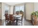 Bright dining area with wood floors and sliding glass door to backyard at 2682 E 161St Pl, Thornton, CO 80602
