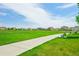 Expansive green space in the community with a walking path and park benches for residents at 2682 E 161St Pl, Thornton, CO 80602