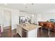 Spacious kitchen with a large island, stainless steel appliances, and breakfast bar at 2682 E 161St Pl, Thornton, CO 80602