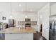 Modern kitchen featuring stainless steel appliances, center island, and tile backsplash at 2682 E 161St Pl, Thornton, CO 80602