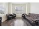 Cozy living room with hardwood floors, comfortable seating, and a large window providing ample natural light at 2682 E 161St Pl, Thornton, CO 80602