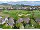 Stunning aerial view of a home in a golf course community with mountain views at 15851 Deer Ridge Dr, Morrison, CO 80465