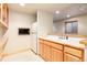 Basement wet bar featuring wood cabinets, a sink, and a mini fridge at 15851 Deer Ridge Dr, Morrison, CO 80465