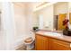 Bright bathroom with tile flooring, a vanity with storage, and tub with shower at 15851 Deer Ridge Dr, Morrison, CO 80465