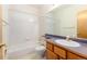 Full bathroom featuring a shower over tub, toilet, and vanity with wood cabinets at 15851 Deer Ridge Dr, Morrison, CO 80465