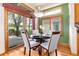 Bright breakfast nook featuring hardwood floors, a modern light fixture, and sliding doors to an outdoor deck at 15851 Deer Ridge Dr, Morrison, CO 80465