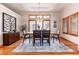 Elegant dining room with tray ceilings, wood floors, and large windows with wooden shutters at 15851 Deer Ridge Dr, Morrison, CO 80465