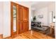Elegant foyer with hardwood floors, a wooden door, and a view into a home office at 15851 Deer Ridge Dr, Morrison, CO 80465