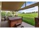 Covered back patio with a hot tub and views of the surrounding neighborhood at 15851 Deer Ridge Dr, Morrison, CO 80465