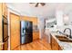 Cozy eat-in kitchen with wood floors, granite countertops, and stainless steel refrigerator at 15851 Deer Ridge Dr, Morrison, CO 80465