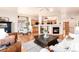 Open-concept space with a living room, kitchen, and breakfast nook with hardwood floors and natural light at 15851 Deer Ridge Dr, Morrison, CO 80465
