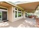 Covered patio featuring a hot tub, brick pillars, and wood beam construction at 15851 Deer Ridge Dr, Morrison, CO 80465