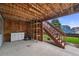 Under-deck view of backyard with shed, stairs, and lawnmower at 1120 N Calhan Ave, Castle Rock, CO 80104