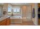 Bright bathroom featuring a soaking tub, separate shower, and bright windows at 1120 N Calhan Ave, Castle Rock, CO 80104