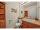 Cozy powder room featuring tiled floors, wooden cabinetry, and modern fixtures at 1120 N Calhan Ave, Castle Rock, CO 80104
