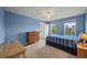 Cozy bedroom with blue walls and a striped bedspread, offering a serene and inviting atmosphere at 1120 N Calhan Ave, Castle Rock, CO 80104