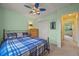 Comfortable bedroom featuring a plaid bedspread, ceiling fan and ample closet space at 1120 N Calhan Ave, Castle Rock, CO 80104