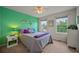Stylish bedroom with vibrant green accent wall and bright natural light at 1120 N Calhan Ave, Castle Rock, CO 80104