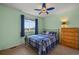 Comfortable bedroom featuring blue plaid bedspread and ceiling fan for a cool and calming space at 1120 N Calhan Ave, Castle Rock, CO 80104