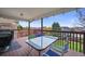 Covered deck area with table and seating overlooking the backyard at 1120 N Calhan Ave, Castle Rock, CO 80104