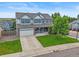 Beautiful two-story home with well-maintained lawn, driveway, and attached two-car garage in a neighborhood setting at 1120 N Calhan Ave, Castle Rock, CO 80104