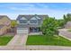 Charming two-story home featuring a well-manicured lawn, blue shutters, and attached two-car garage at 1120 N Calhan Ave, Castle Rock, CO 80104