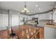 Spacious kitchen with white cabinets, an island, stainless steel appliances, and a dining area at 1120 N Calhan Ave, Castle Rock, CO 80104