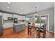 Bright kitchen features white cabinets, stainless steel appliances, a kitchen island and hardwood flooring at 1120 N Calhan Ave, Castle Rock, CO 80104