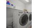 A well-equipped laundry room featuring a modern, white LG washer and dryer set and storage shelves at 1120 N Calhan Ave, Castle Rock, CO 80104