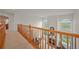 Open loft area overlooking the living room with large windows and a fireplace at 1120 N Calhan Ave, Castle Rock, CO 80104