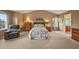 Bright main bedroom featuring a floral-patterned bedspread, vaulted ceilings, and plush armchair at 1120 N Calhan Ave, Castle Rock, CO 80104