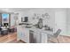 Modern kitchen island with white cabinets and stainless steel dishwasher at 22022 E 38Th Pl, Aurora, CO 80019