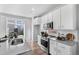 Kitchen features stainless steel appliances and white cabinets at 22022 E 38Th Pl, Aurora, CO 80019
