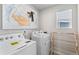 Bright laundry room features washer, dryer, and folding rack at 22022 E 38Th Pl, Aurora, CO 80019