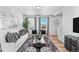 Spacious living room with large windows and stylish furnishings at 22022 E 38Th Pl, Aurora, CO 80019