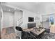 Open concept living room with modern furnishings and a view into the kitchen at 22022 E 38Th Pl, Aurora, CO 80019