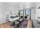 Living room features a white couch and large windows at 22022 E 38Th Pl, Aurora, CO 80019