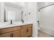 Bright bathroom featuring double sink vanity, modern fixtures, and tub with shower at 39730 Congress Ln, Elizabeth, CO 80107
